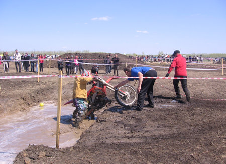 Russia, Novosibirsk 07.05.2011: biker overcomes an obstacle on the motocross trackのeditorial素材