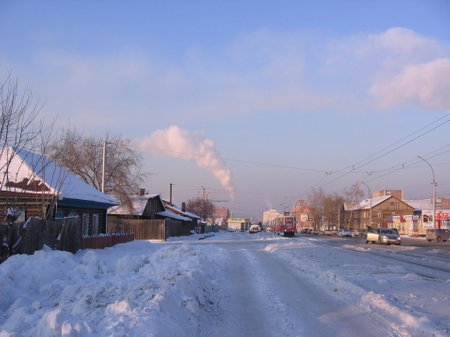 Russia, Novosibirsk, 01.01.1980: road past fences in the village of Siberia tram on rails in winter in the snowのeditorial素材