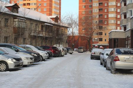 parked cars near historic high-rise buildings in Novosibirsk narymskaya street in winter lack of Parking spacesのeditorial素材