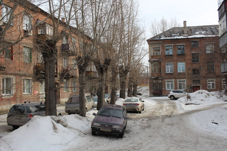 Russia, Novosibirsk, 03/15/2020: parked cars in winter near a residential building on the drivewayのeditorial素材
