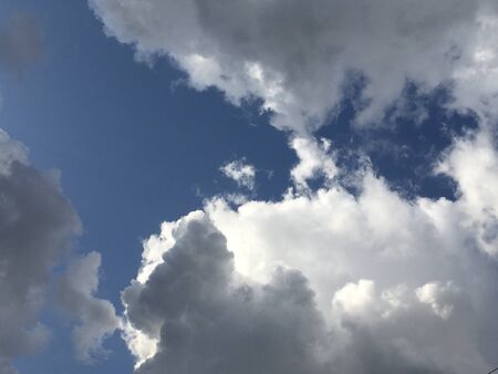 Dramatic sky with stormy clouds in sunny dayの写真素材