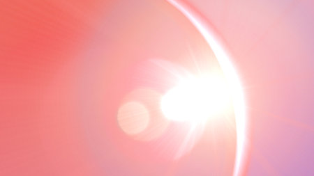 A beautiful abstract background featuring a soft pink gradient with a bright, central lens flareの写真素材