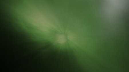 green abstract background with rays of light and bokeh effect.の写真素材