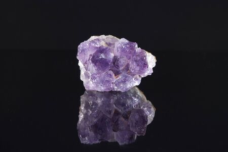 Raw amethyst on black reflective backgroundの写真素材