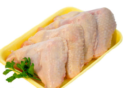 Raw chicken wings with green salad, high angle view, clipping path includedの写真素材