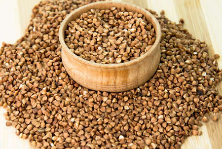 Buckwheat scattered on the desktop and in the plateの写真素材