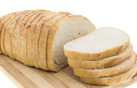 cutting wheat bread on a white background