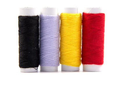 Colorful spools of thread isolated on white background