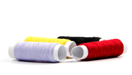 Colorful spools of thread isolated on white background