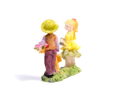 The statue of lovers boy and girl isolated on white backgroundの写真素材