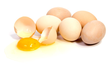 Broken egg in eggshell half and raw egg isolated on white background cutout