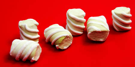 Pile of marshmallows glazed . Many coated elegant zephyr dessert isolated on white. Sweet elegant dessert on a plateの写真素材