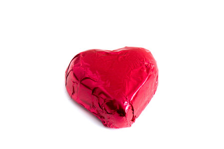 Crumpled ball of aluminum foil isolated on white background.