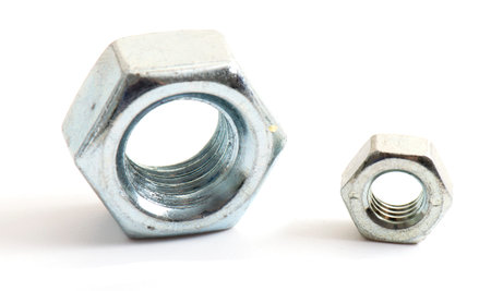 Macro shot metal nut isolated on white background. Chromed screw nut isolated. Steel nut isolated....