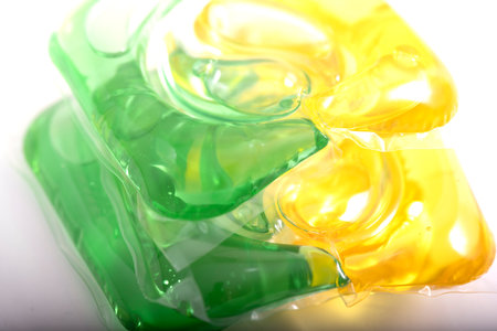 Washing gel capsule pod with laundry detergent isolated on white background.の写真素材