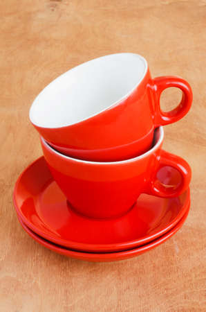 Home Kitchen Decor: the ceramic empty red cups on a wooden background.の写真素材
