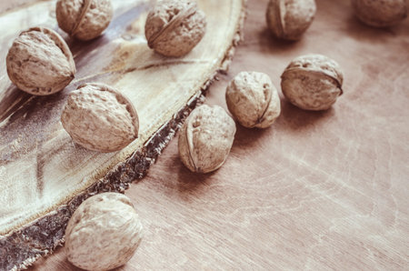 Whole walnuts on rustic old wooden table. Rustic style.