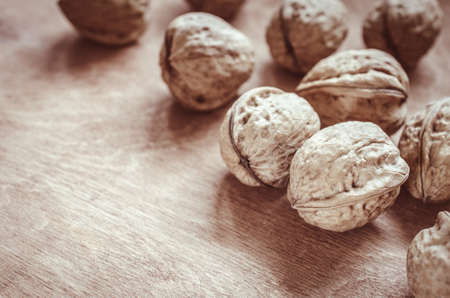 Whole walnuts on rustic old wooden table. Rustic style.の写真素材