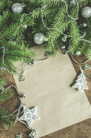 Xmas decoration with blank postcard on wooden background. Copy space. Seasonal and holidays concept. Selective focus, space for text.の写真素材