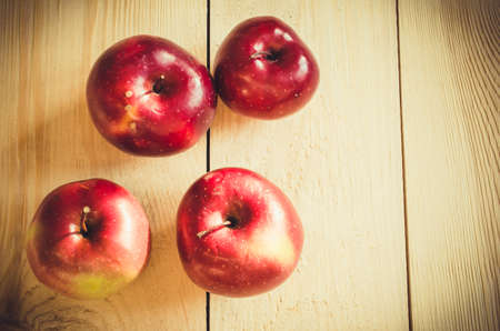 Fresh organic apples on rustic wooden background. Selective Focus. Rustic style. Toned image.の写真素材
