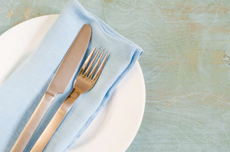 Spring table settings with fresh flower, napkin and silverware. Holidays background. Selective Focus.の写真素材