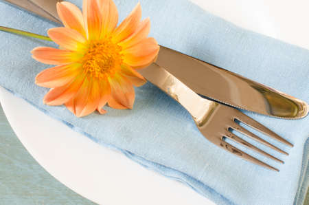 Spring table settings with fresh flower, napkin and silverware. Holidays background. Selective Focus.の写真素材