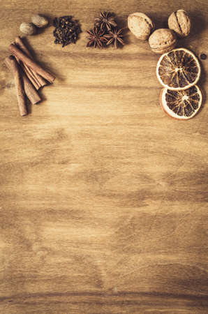 Culinary Background. Spices for Christmas Baking on a Wooden Table. Top view. Copy space. Selective focus. Toned image.の写真素材