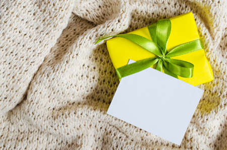 Gift Box. Present With Empty Postcard on Knitted blanket background. Selective focus.の写真素材