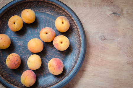 Fresh Organic Apricot in Rustic Plate. Selective Focus.の写真素材