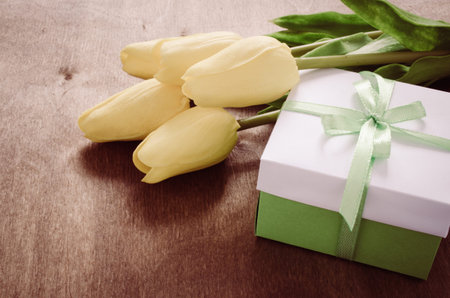 Festive Table Setting in White, Green and Yellow With Tulip. Concept Spring, Easter or Mother's Day. Selective Focus. Toned Image.の写真素材