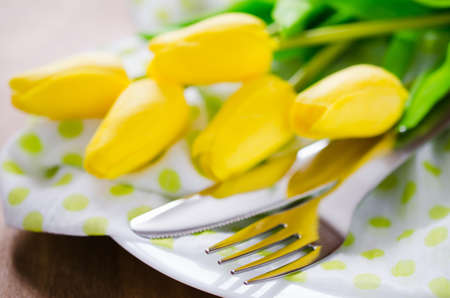 Festive Table Setting in White, Green and Yellow With Tulip. Concept Spring, Easter or Mother's Day. Selective Focus.の写真素材