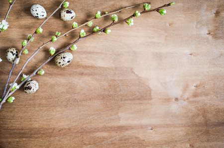 Festive table setting for Easter dinner with spring flowers and cutlery on wooden rustic table....
