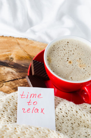 Cup of Hot Cappuccino and Chocolate in the Bed, Notes Time to Relax, Lazy Morning. Selective Focus.