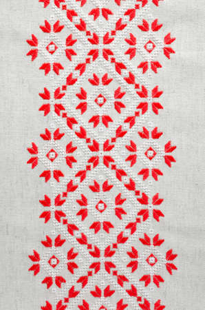Element handmade embroidery on linen by red and white cotton threads. Vintage texture design. Design of ethnic pattern.の写真素材