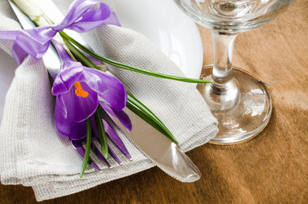 Spring Festive Table Setting With Fresh Flower. Napkin, plate and cutlery on wooden table. Holidays...