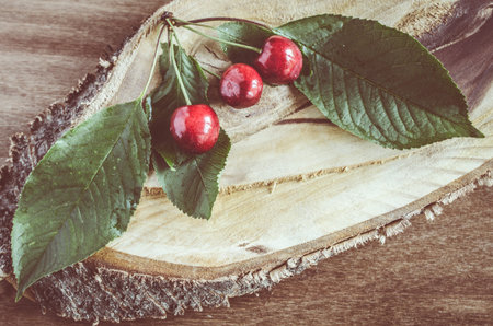 Fresh ripe organic cherries on wooden background. Vintage rustic style. Selective focus.の写真素材
