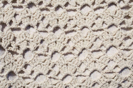 Vintage Beige Knitted Fabric Texture. Crochet Warm Woolen Yarn Background. Close-up. Selective focus.の写真素材
