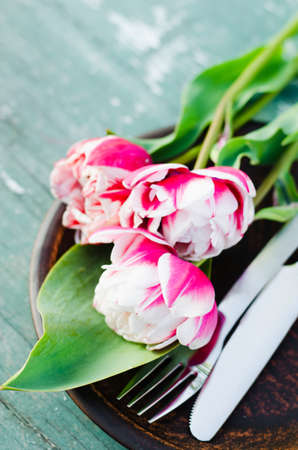 Festive Table Setting With Pink Tulips. Holiday Table Set for Mother's Day or Birthday. Selective Focus.の写真素材