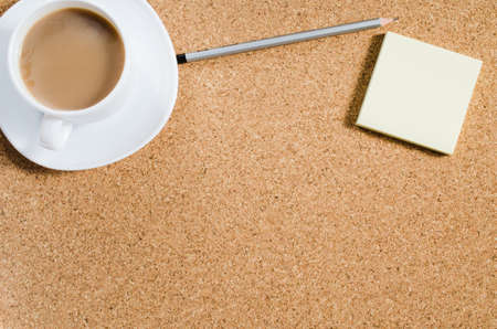 Top view image of blank notes next to cup of coffee on cork board. Ready for adding text or mockup. Flat lay.の写真素材