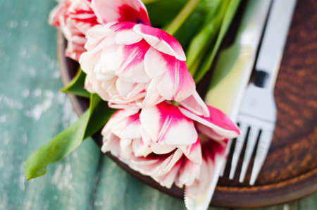 Festive Table Setting With Pink Tulips. Holiday Table Set for Mother's Day or Birthday. Selective Focus.の写真素材