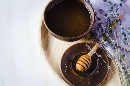 Organic honey and lavender flowers on wooden table. Rustic stile.の写真素材