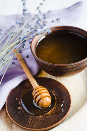Organic honey and lavender flowers on wooden table. Rustic stile.の写真素材