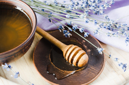 Organic honey and lavender flowers on wooden table. Rustic stile.の写真素材