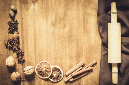 Culinary Background. Spices and tools for Christmas Baking on a Wooden Table. Top view. Copy space. Selective focus. Toned image.の写真素材