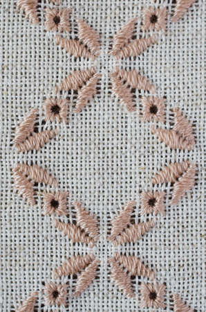 Element handmade embroidery on linen by brown and beige cotton threads. Craft embroidery. Design of ethnic pattern.の写真素材