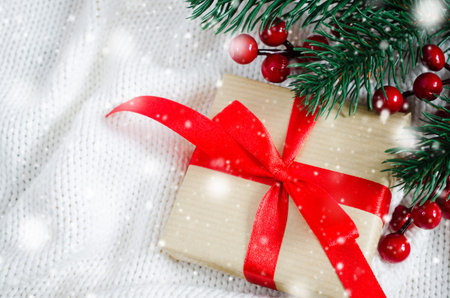 Christmas background with decorations and gift boxes on knitted board blanket. Xmas presents with...