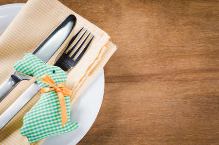 Spring Festive Table Setting for Easter Dinner with Cutlery and Napkin on Wooden Rustic Table. Selective Focus.の写真素材