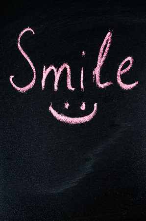 Inscription Smile on a Dark Background. Top View.の写真素材