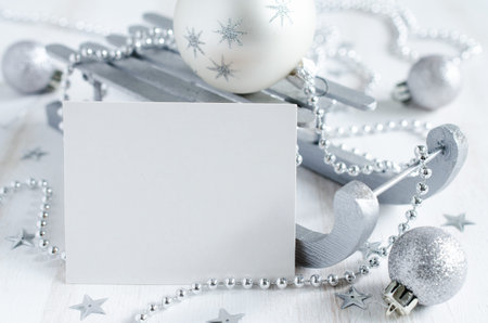 Christmas background with silver xmas decoration. Blank postcard on wooden background. Copy space....