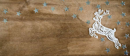 Christmas Background for Holiday Card in Rustic Style. Xtmas Decorative Deer on Wooden Board. Copy Space for Your Text. Toned image.の写真素材
